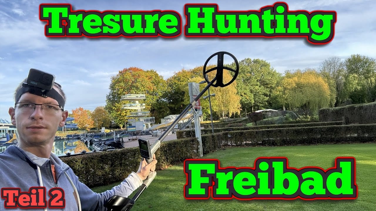 Ein Mann mit Brille und Kopfkamera benutzt eine Schatzsuche Metalldetektor auf einer Wiese in der Nähe eines Pools. Der Text "Tresure Hunting Freibad Teil 2" erscheint in leuchtendem Grün und Rot. Im Hintergrund sind Herbstbäume zu sehen.