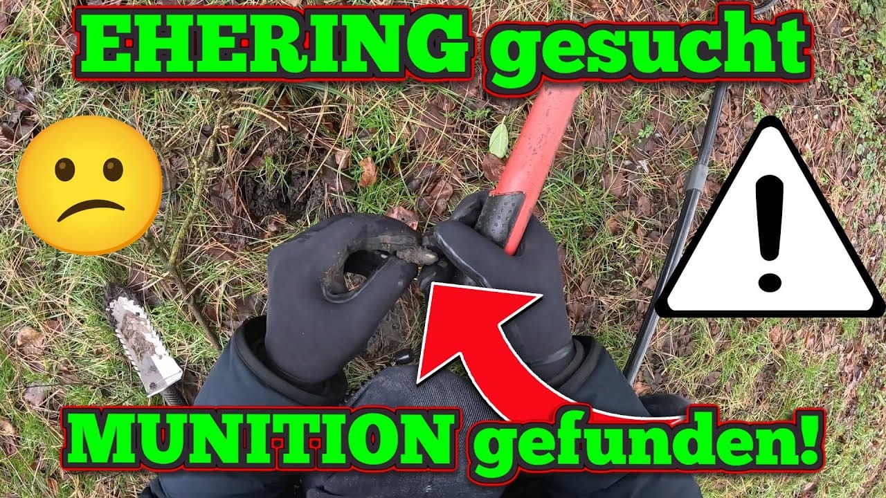 Eine Person mit schwarzen Handschuhen gräbt mit einem roten Werkzeug in der Erde, vielleicht auf einer Schatzsuche mit Metalldetektor. Der Text lautet EHERING gesucht, MUNITION gefunden! Ein trauriges Emoji und ein Warnschild erscheinen vor einem Hintergrund aus Gras und Erde.